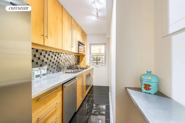 a view of a kitchen with a sink and wooden floor