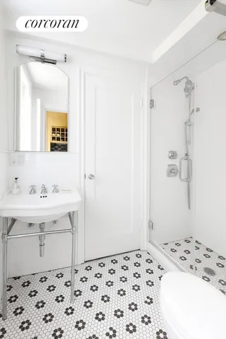 a bathroom with a sink a mirror and a shower