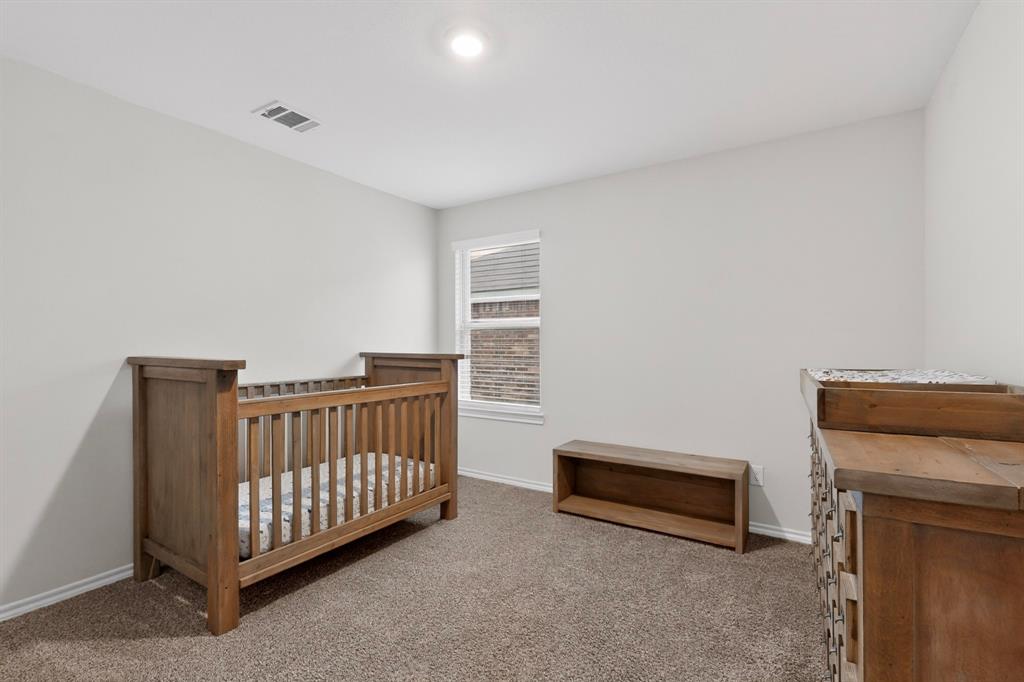 2945 Roper Street Royse City, TX 75189 - Photo 12 of 25 a bedroom with furniture and a window