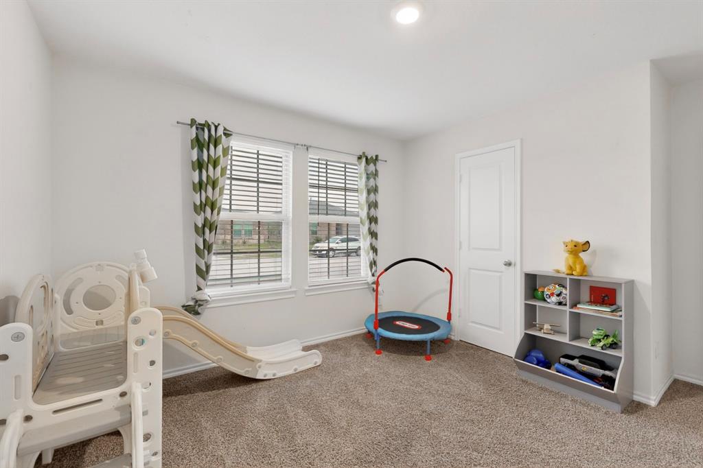 2945 Roper Street Royse City, TX 75189 - Photo 15 of 25 a room with a bed and a window