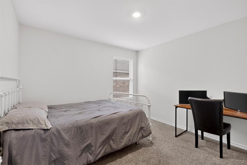 2945 Roper Street Royse City, TX 75189 - Photo 16 of 25 a bedroom with a bed and chair