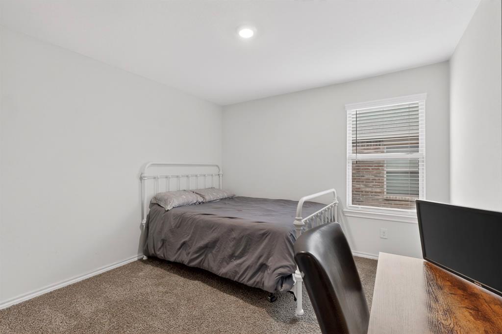 2945 Roper Street Royse City, TX 75189 - Photo 17 of 25 a bedroom with a bed and a window