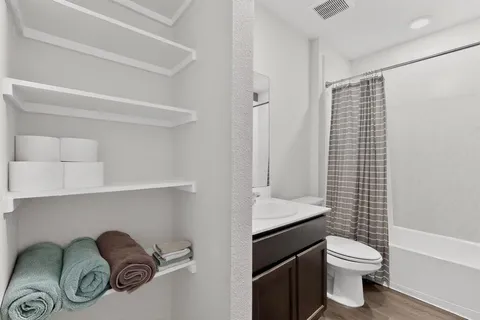 a bathroom with a sink toilet and shower