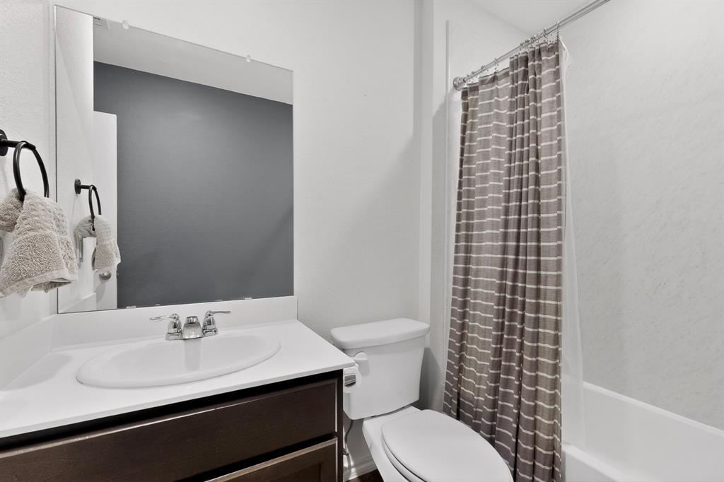 2945 Roper Street Royse City, TX 75189 - Photo 19 of 25 a bathroom with a sink a toilet and shower