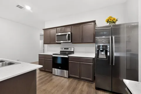 a kitchen with stainless steel appliances and wooden cabinets