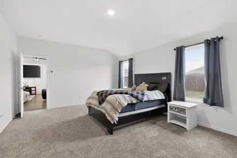 a bed room with a bed and a mirror