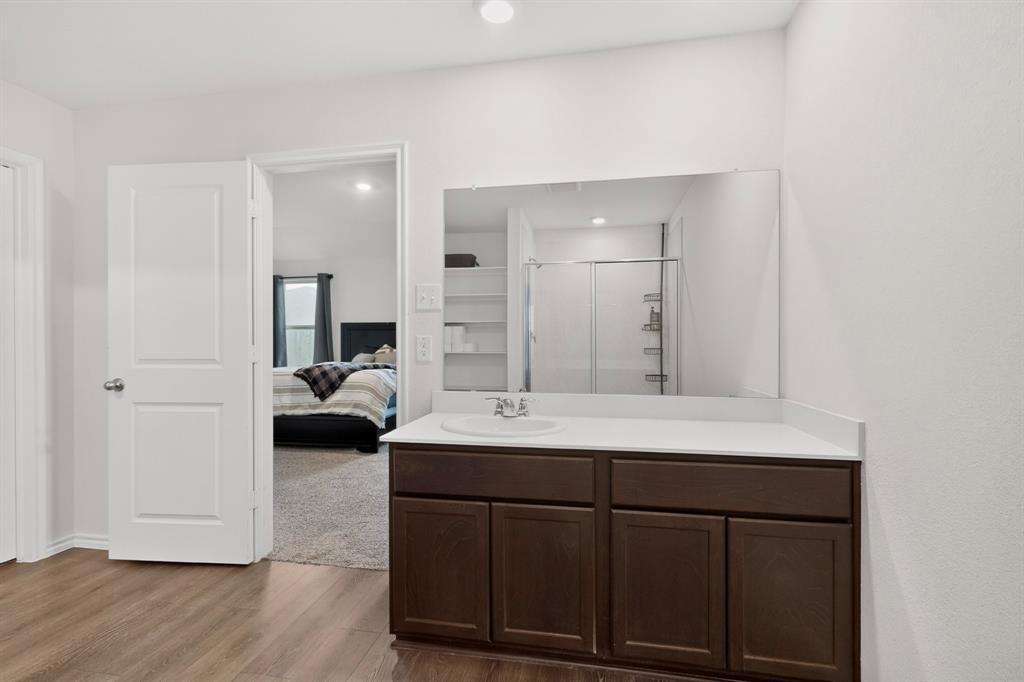 2945 Roper Street Royse City, TX 75189 - Photo 10 of 25 a en suite bathroom with a double vanity sink and mirror