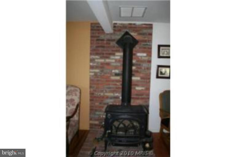6371 Waterloo Road Elkridge, MD 21075 - Photo 6 of 25 Wood stove with brick hearth