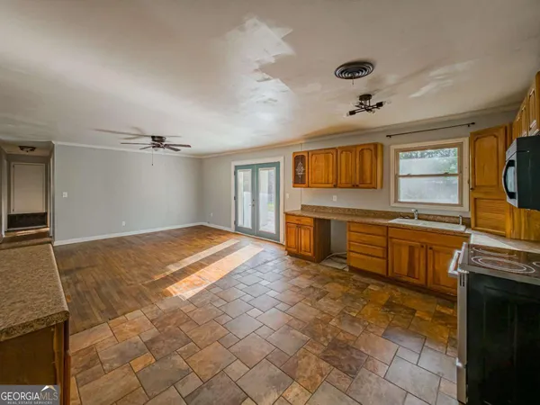 a open kitchen with stainless steel appliances a stove and cabinets