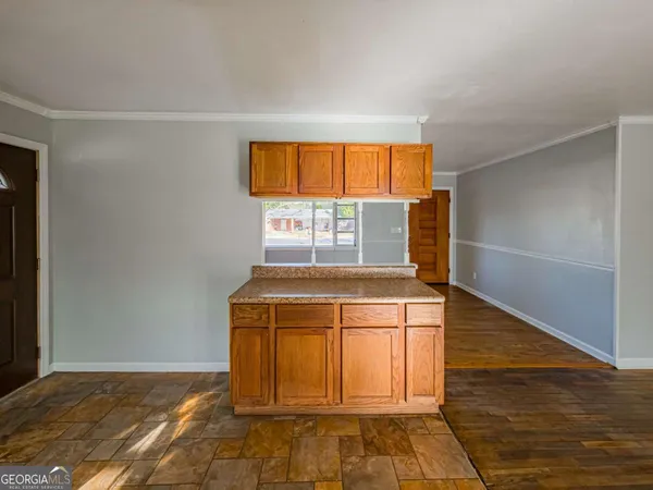 a view of a kitchen with wooden floor and windows