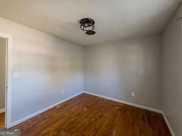 a view of a room with wooden floor