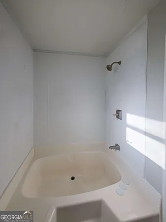 a white bath tub sitting in a bathroom