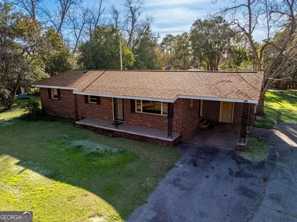 a aerial view of a house with a garden and deck