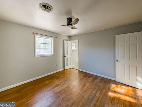 wooden floor in an empty room with a window