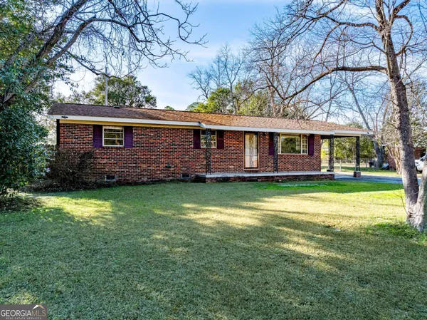 a front view of house with yard and swimming pool