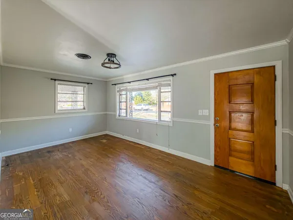 wooden floor in an empty room with a window