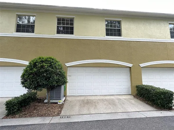 a front view of a house with plants