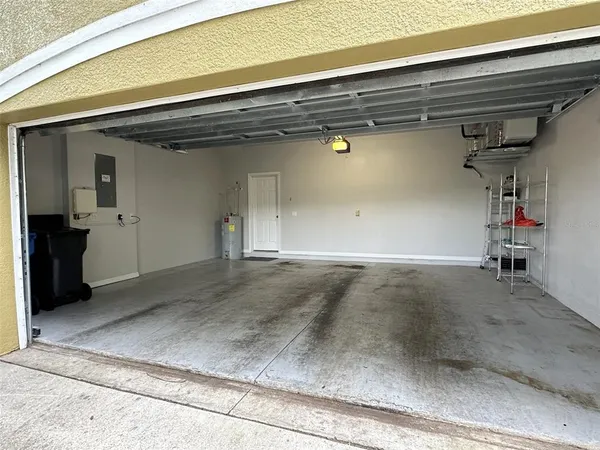 a view of a street with a bench and trees