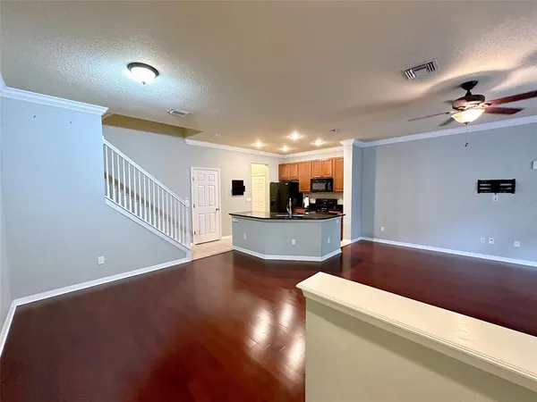 a view of kitchen and hall with wooden floor