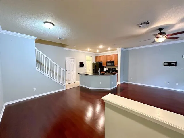 a view of kitchen and hall with wooden floor