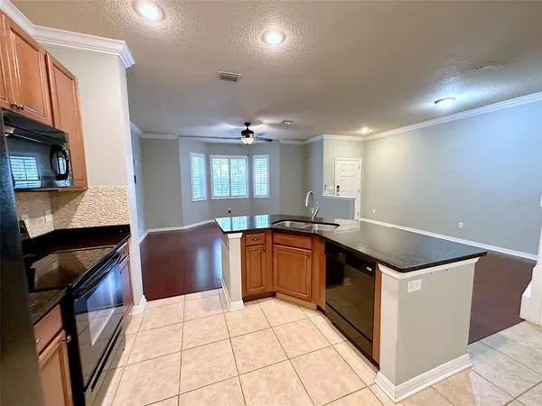 a kitchen with stainless steel appliances granite countertop a sink and cabinets