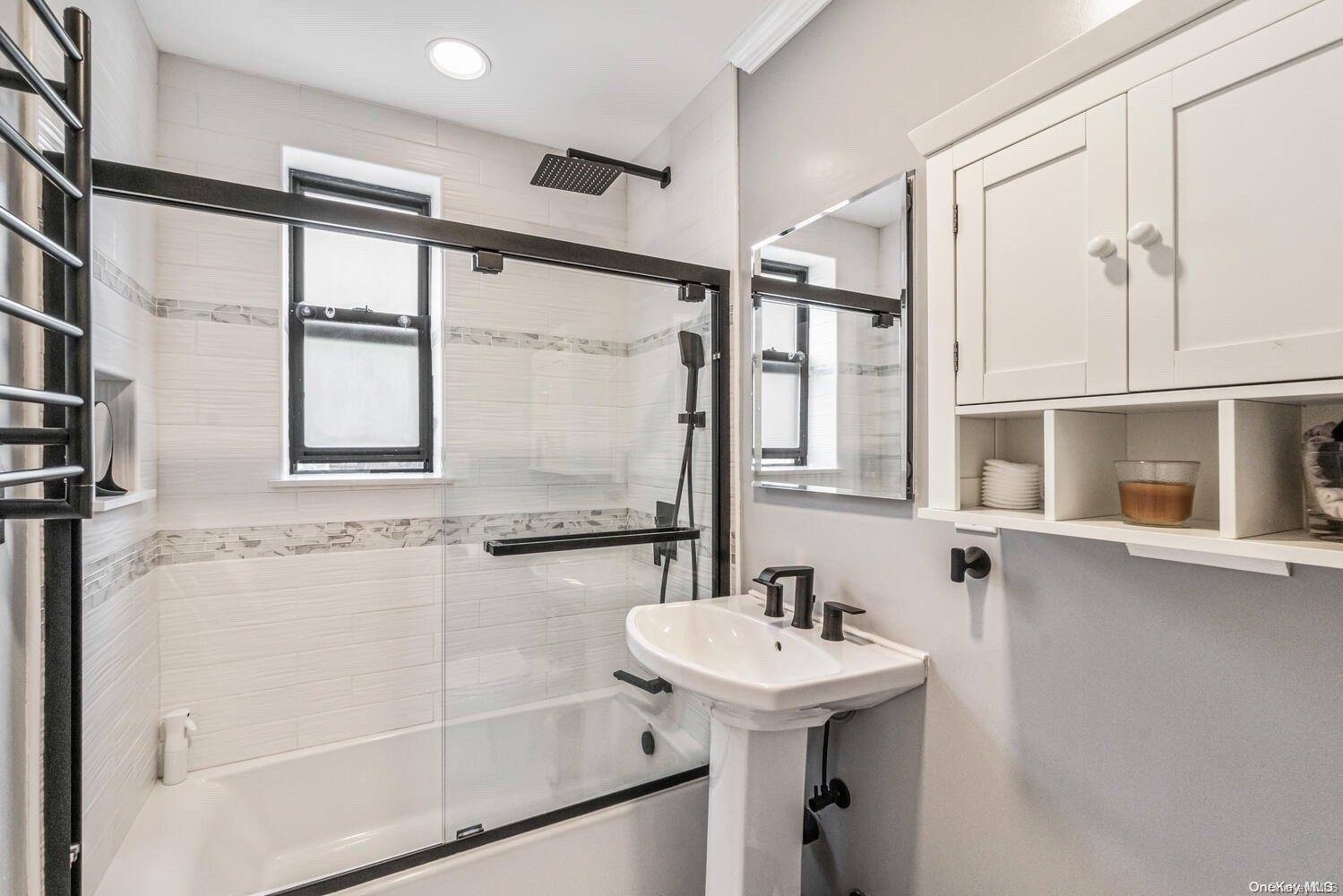 84-19 51st Avenue, Unit 1P Queens, NY 11373 - Photo 12 of 18 a bathroom with a sink and a mirror