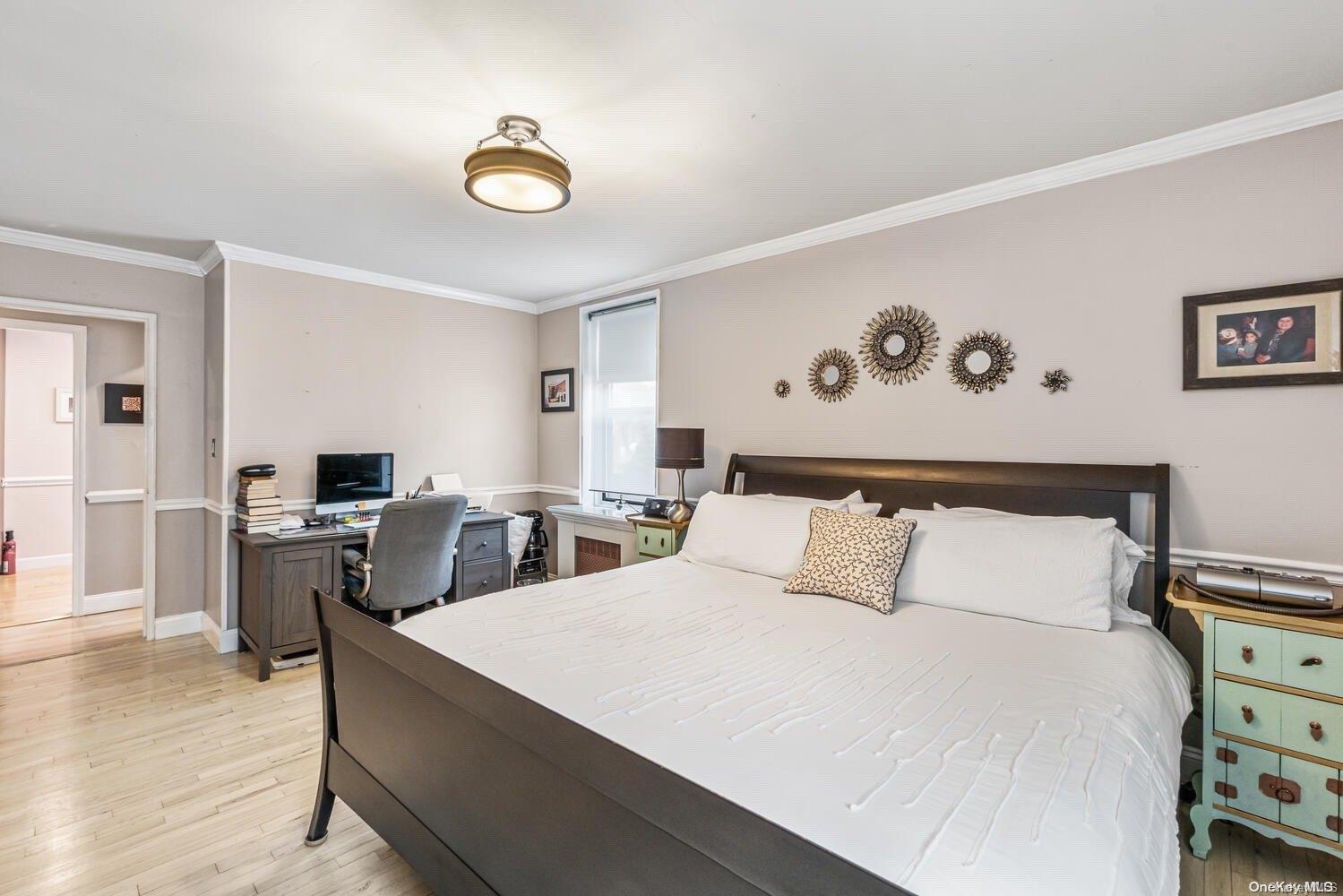 84-19 51st Avenue, Unit 1P Queens, NY 11373 - Photo 14 of 18 a bedroom with a bed and a view of kitchen