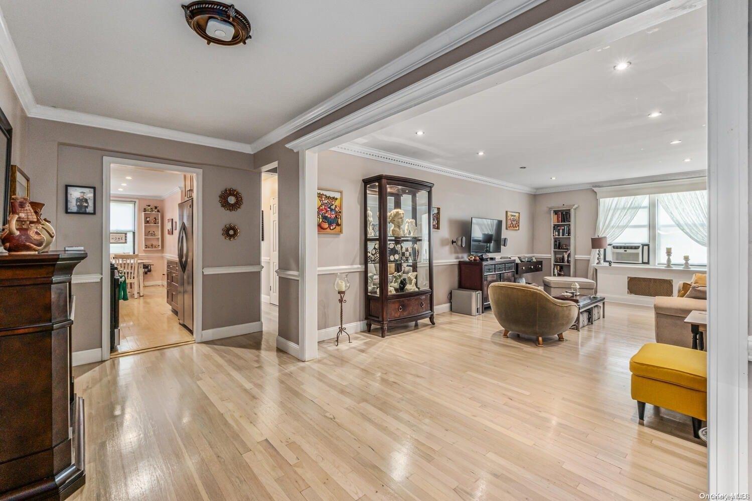 84-19 51st Avenue, Unit 1P Queens, NY 11373 - Photo 3 of 18 a view of a living room kitchen and a wooden floor