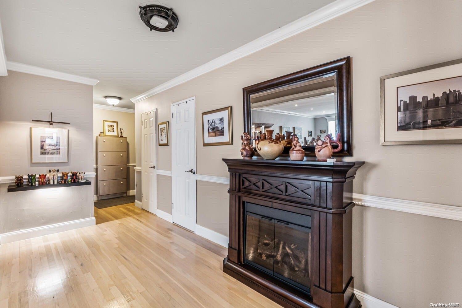 84-19 51st Avenue, Unit 1P Queens, NY 11373 - Photo 4 of 18 a living room with furniture and a fireplace