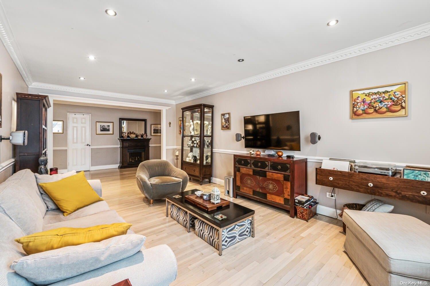 84-19 51st Avenue, Unit 1P Queens, NY 11373 - Photo 7 of 18 a living room with furniture and a flat screen tv