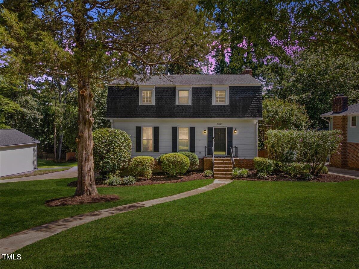 3317 Harden Road Raleigh, NC 27607 - Photo 1 of 53 a view of a house with a yard and a garden