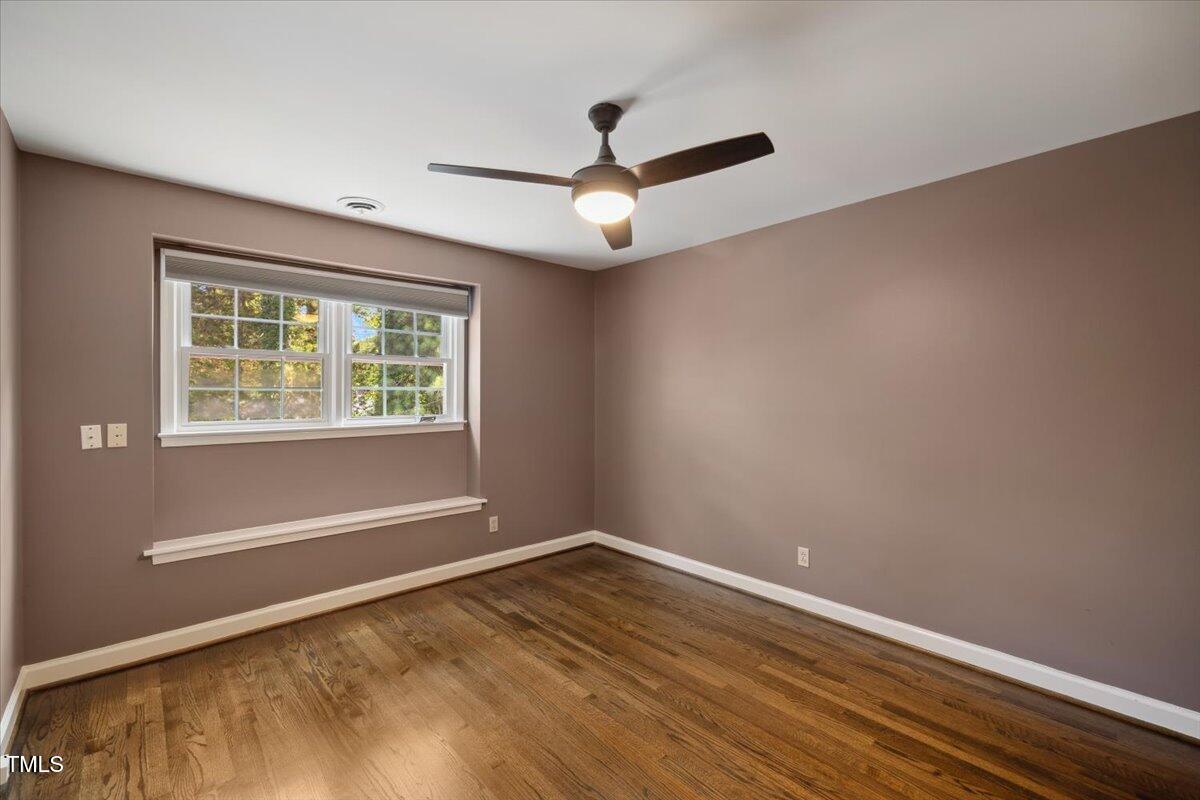 3317 Harden Road Raleigh, NC 27607 - Photo 27 of 53 an empty room with wooden floor ceiling fan and windows