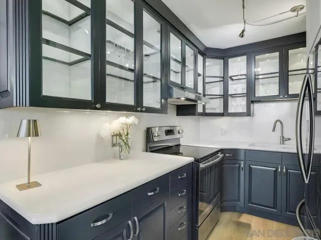 a kitchen with stainless steel appliances granite countertop a refrigerator and a sink