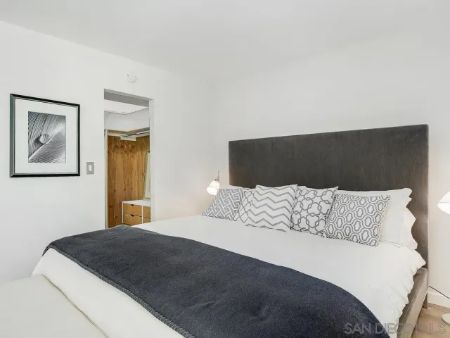 a large bedroom with a large bed and wooden floor