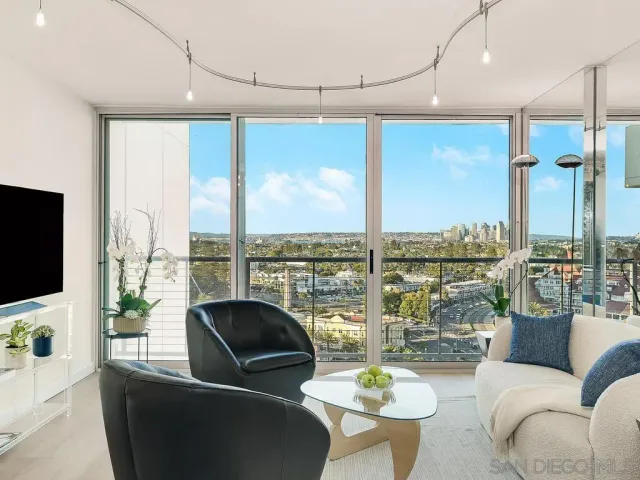 a living room with patio furniture and a flat screen tv