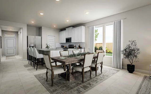 a view of a dining room with furniture and a window