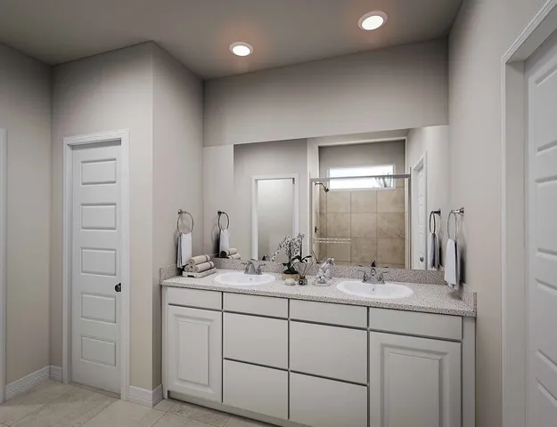 a bathroom with a double vanity sink and mirror