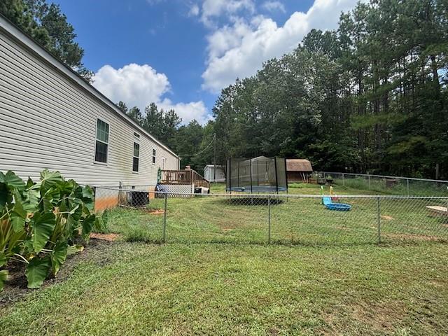 2477 Shoal Creek Road Colbert, GA 30628 - Photo 17 of 19 a view of a house with backyard