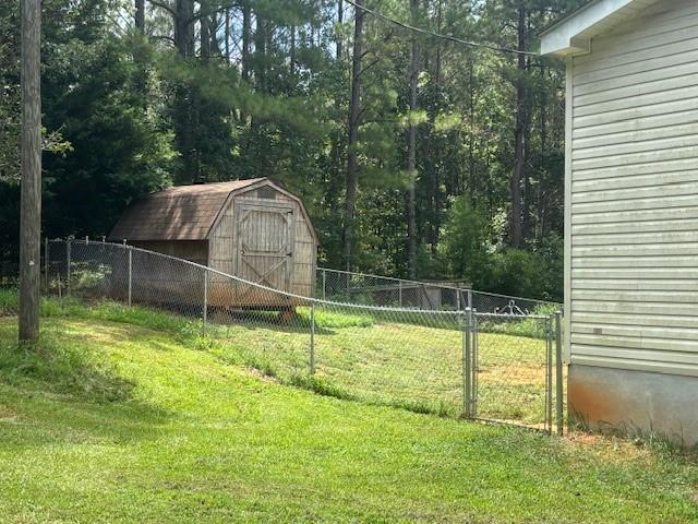 2477 Shoal Creek Road Colbert, GA 30628 - Photo 19 of 19 a view of a backyard with a small cabin