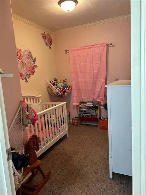 2477 Shoal Creek Road Colbert, GA 30628 - Photo 9 of 19 a bedroom with a baby bed a couch and a window