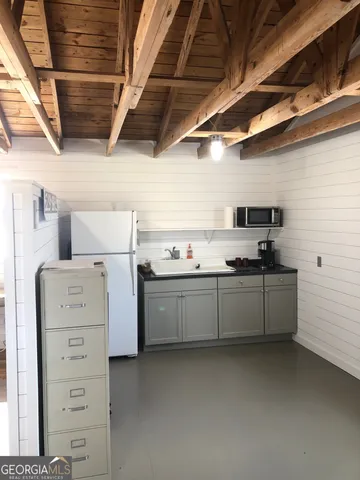 a kitchen with sink cabinets and appliances
