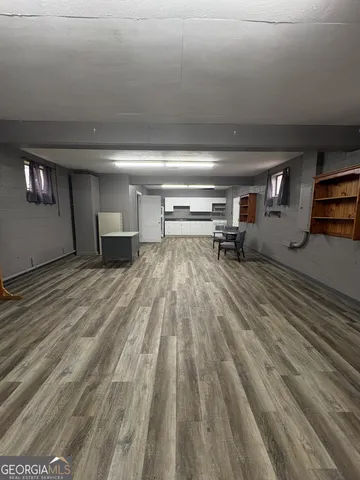 a view of a livingroom with wooden floor and furniture