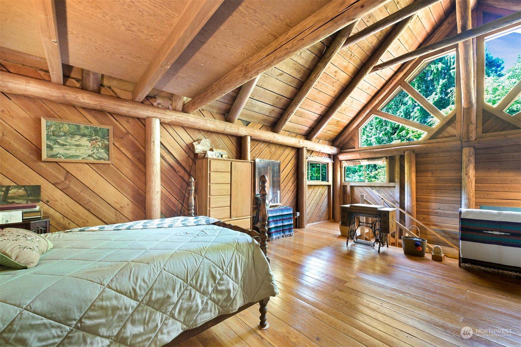 2125 Butler Creek Road Sedro-Woolley, WA 98284 - Photo 17 of 40 a bedroom with a bed a table and wooden floor