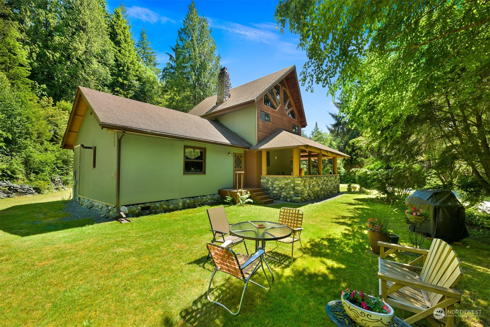 2125 Butler Creek Road Sedro-Woolley, WA 98284 - Photo 4 of 40 a backyard of a house with table and chairs
