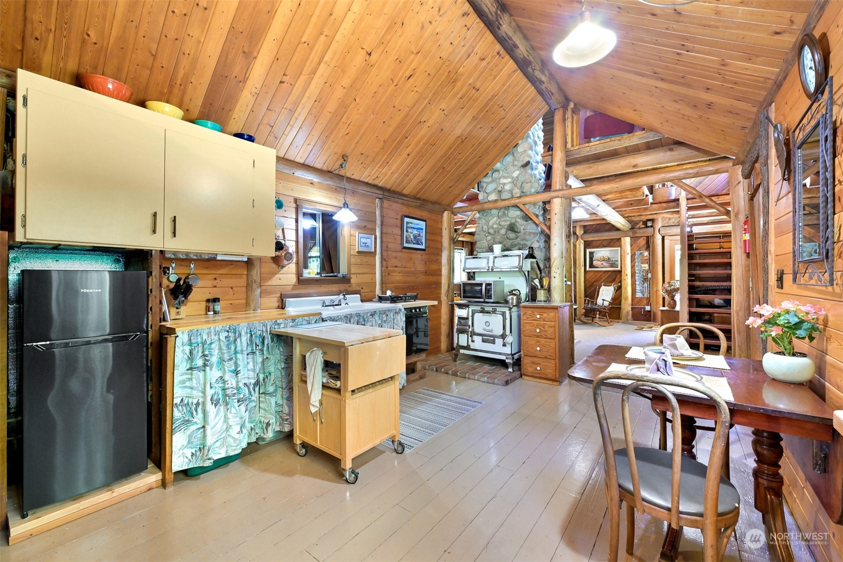 2125 Butler Creek Road Sedro-Woolley, WA 98284 - Photo 9 of 40 a kitchen with a table chairs refrigerator and cabinets