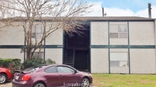 a front view of a house with parking space