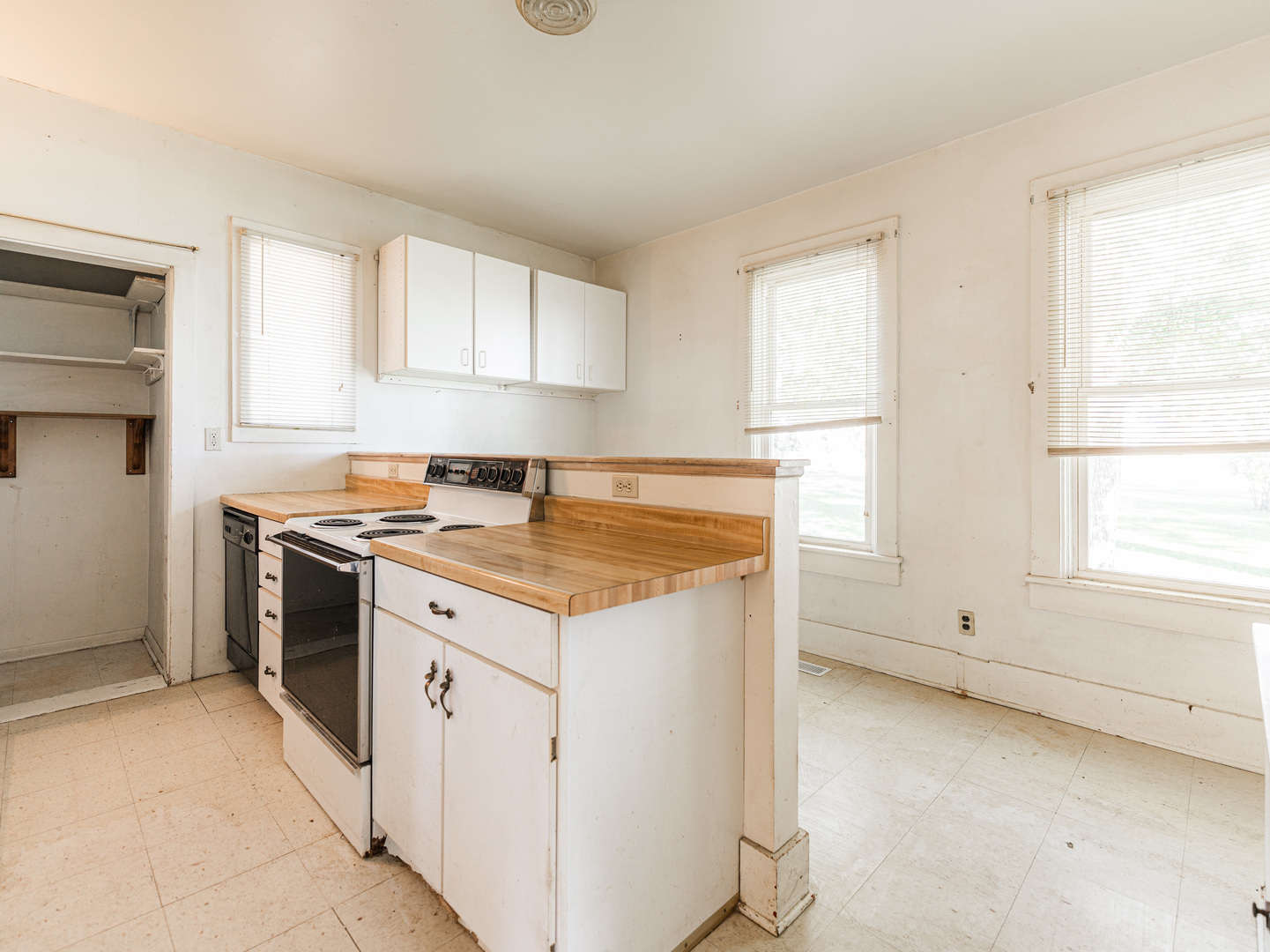 18107 University Road Malta, IL 60150 - Photo 8 of 31 a kitchen with granite countertop white cabinets and white appliances