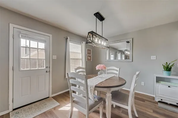 a view of a dining room with furniture wooden floor and chandelier