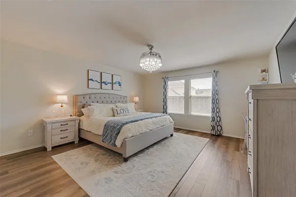 a spacious bedroom with a bed and a window