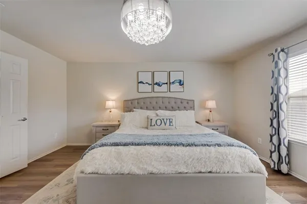 a bedroom with a bed and a chandelier